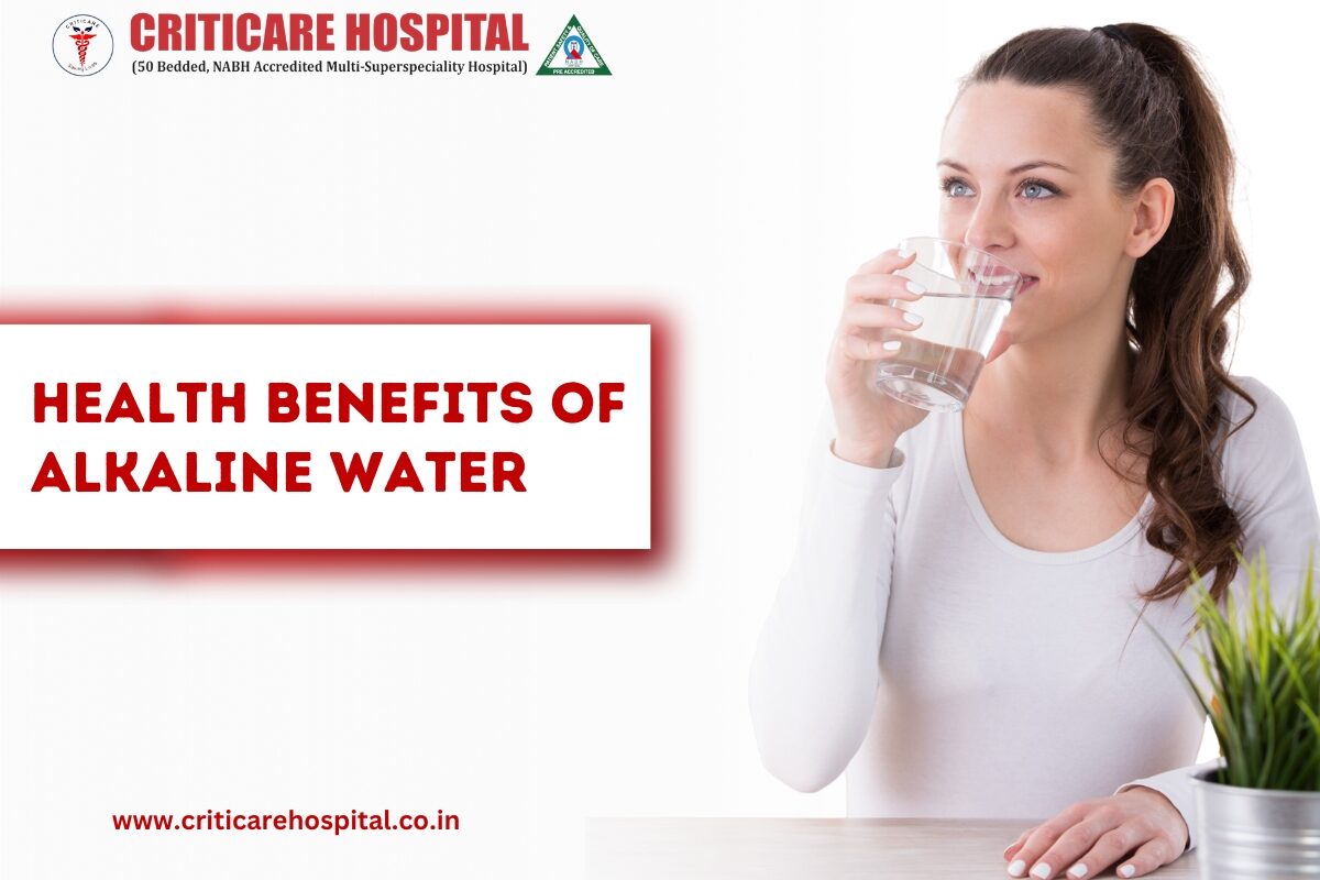 Woman drinking a glass of water with text “Health Benefits of Alkaline Water” on a Criticare Hospital banner.
